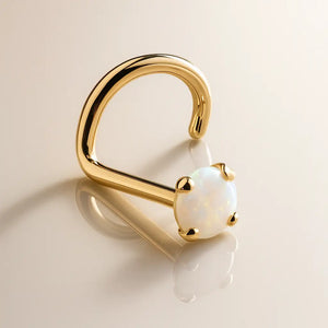 14K yellow gold opal nose ring twist style, angled view showing iridescent prong-set cabochon
