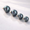 Four peacock pearl 14K gold internally threaded replacement balls shown in graduating sizes on white surface