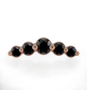 Front view of 14K rose gold black diamond climber charm highlighting warm tone against black stones