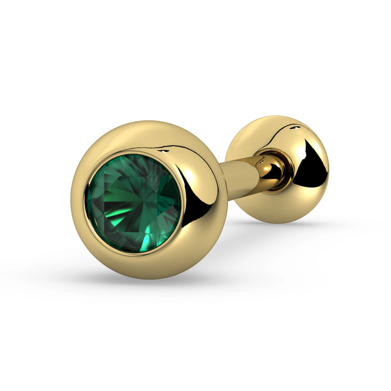 14K yellow gold tongue ring barbell with vivid green emerald in bezel setting, angled close-up view