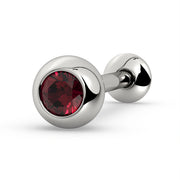14K white gold tongue barbell with ruby gemstone in solid bezel ball, angled view on white background