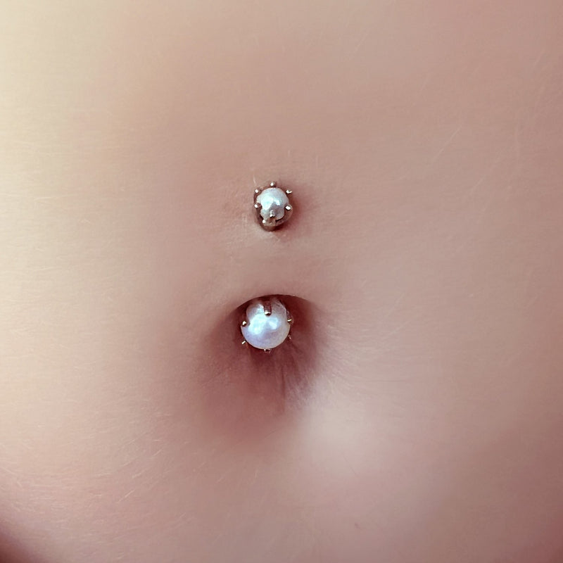 Close-up of Akoya pearl belly ring in navel piercing showing 3mm top and 5mm bottom pearl detail