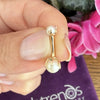 14k yellow gold Akoya pearl belly ring held in hand for size reference near FreshTrends pouch