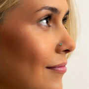 3mm aqua diamond perlage nose ring in yellow gold shown in pierced nose, side profile on model
