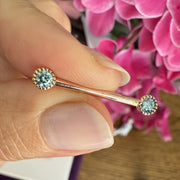 14k rose gold aqua diamond Perlagé nipple barbell held in hand for size reference