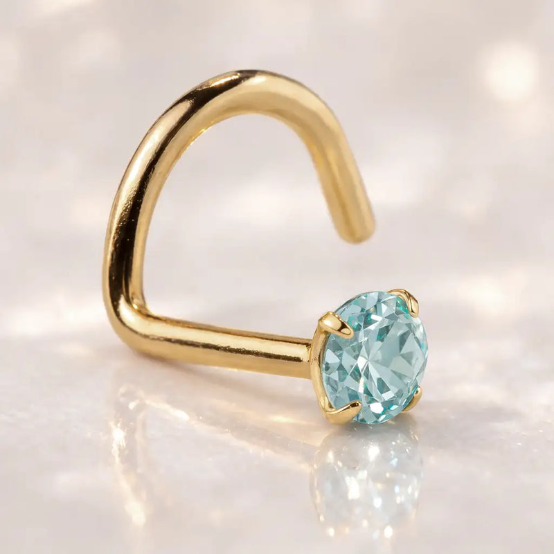 14K yellow gold aquamarine nose ring twist style with blue-green prong-set stone, lifestyle shot