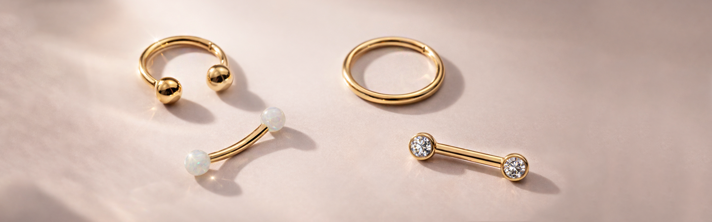 Gold jewelry on a soft pink background