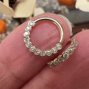 14k yellow gold bubbles seam ring held between fingers for size and scale reference