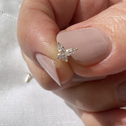 14k yellow gold diamond butterfly nose ring end held between fingers for size reference