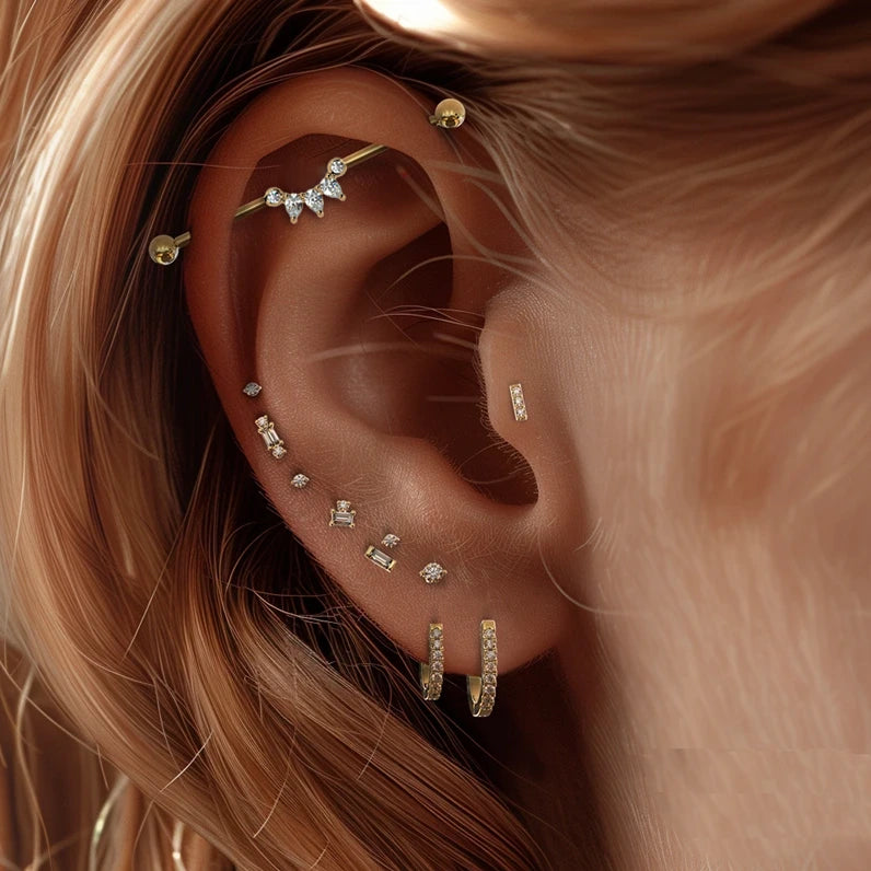 Celeste Arc industrial barbell shown in ear piercing, styled with curated gold cartilage jewelry