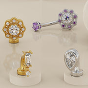 Assortment of 14k gold floating belly rings including the teardrop style in white gold