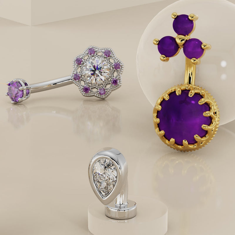Collection display of three belly rings including petite teardrop CZ floating navel ring in white gold