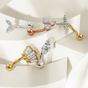 Collection of 14k gold curved barbells in yellow, rose, and white gold on tiered display