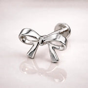 14k white gold classic bow flat back stud, side-angled view showing polished finish and labret post