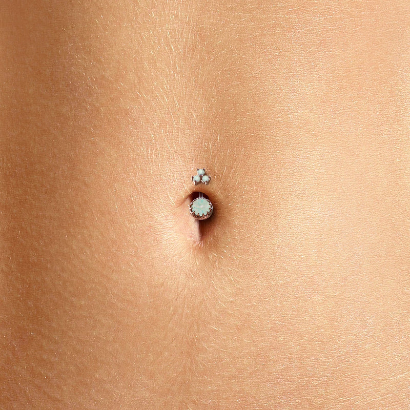 White opal crown navel ring shown in a belly piercing, close-up fit view on model