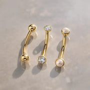 Three gold curved barbells