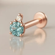 14k rose gold aquamarine and diamond accent flat back labret showing warm gold tone contrast with blue gem