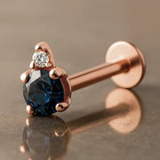 14k rose gold flat back labret with round blue sapphire and diamond accent, angled side view