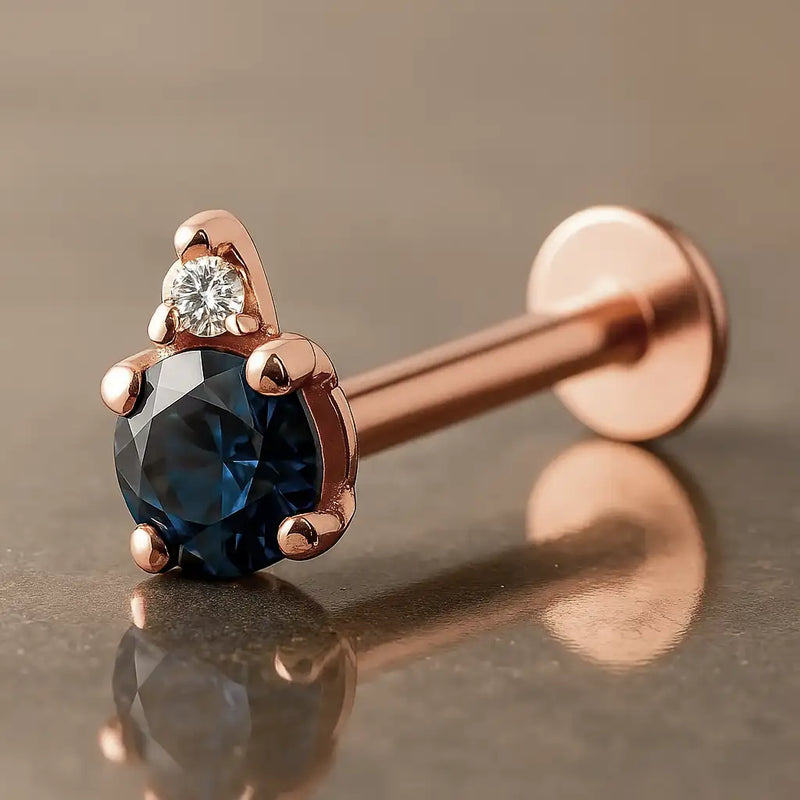 14k rose gold flat back labret with round blue sapphire and diamond accent, angled side view