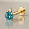14k yellow gold blue topaz and diamond flat back labret, angled view showing prong setting and flat disc