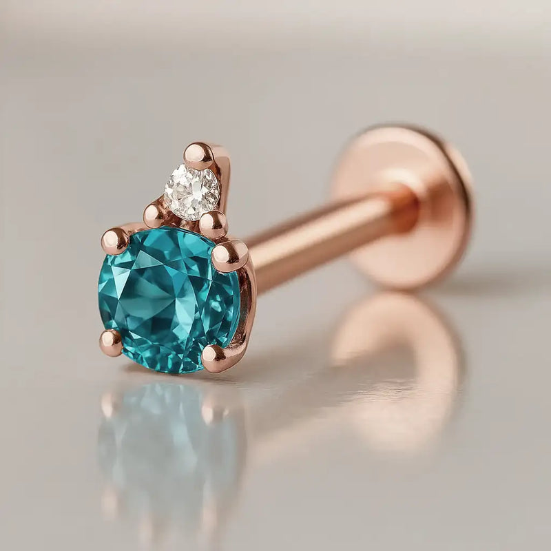 14k rose gold blue topaz and diamond accent flat back labret, angled view showing warm gold tone setting