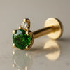 14k yellow gold emerald and diamond accent flat back labret, angled view showing prong setting detail