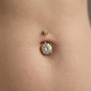 14k yellow gold diamond belly ring shown in navel piercing, close-up fit on model