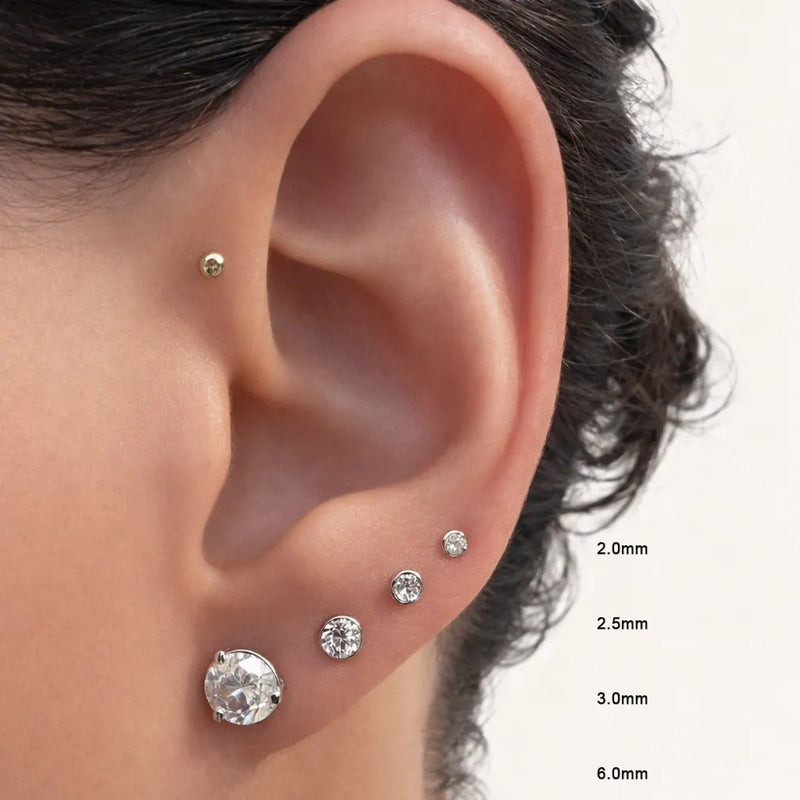 Diamond bezel flat back stud size comparison 2mm to 6mm worn in lobe and cartilage piercings on model