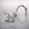 14k white gold diamond butterfly nose ring with twist backing on reflective surface
