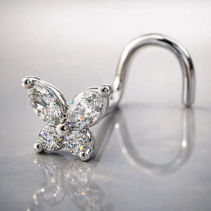 14k white gold diamond butterfly nose ring with twist backing on reflective surface