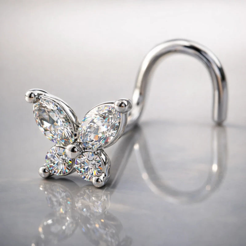 14k white gold diamond butterfly nose ring with twist backing on reflective surface