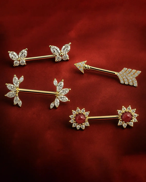 Set of gold jewelry pieces including butterfly, arrow, and flower designs on a red background