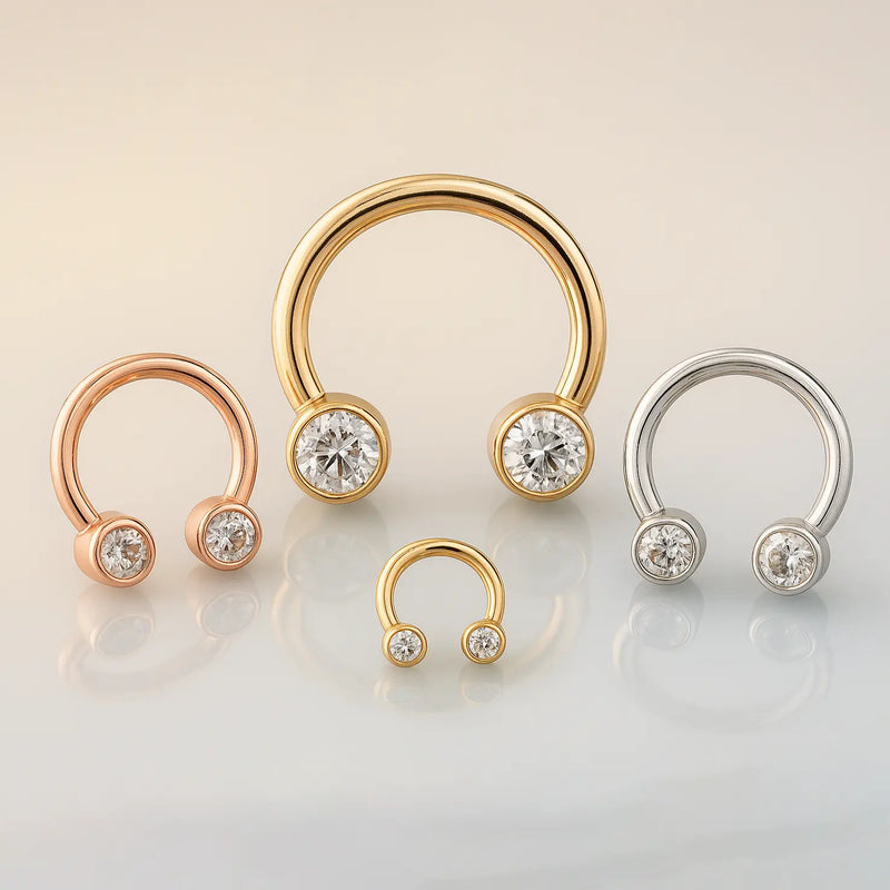 CZ bezel circular barbells in rose gold, yellow gold, and white gold shown in multiple sizes together
