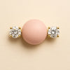 Close-up of 14k yellow gold diamond nipple barbell ends showing four-prong round brilliant diamond settings and scale