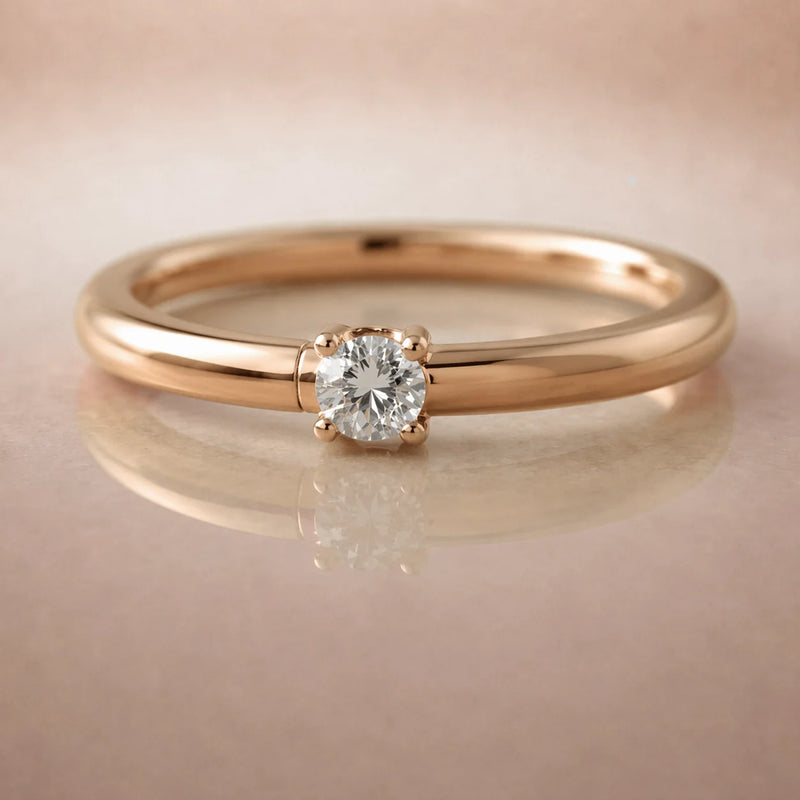 14K rose gold diamond side-set seam ring hoop with prong-set round diamond, on reflective surface