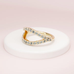 14k yellow gold pavé diamond split seam ring displayed on white ceramic prop, side profile view