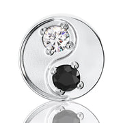 Close-up of 14k white gold yin yang stud showing prong-set white and black diamond detail