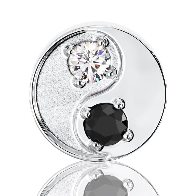 Close-up of 14k white gold yin yang stud showing prong-set white and black diamond detail