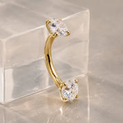 Diamond curved barbell for navel, eyebrow, and rook piercings on a stand. 