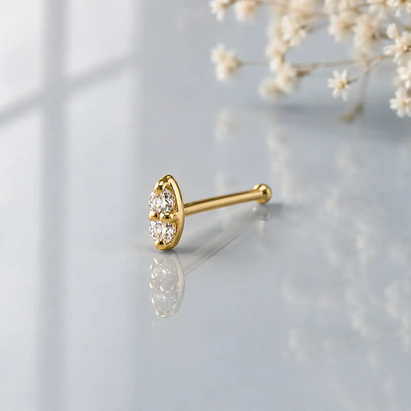 14K yellow gold double diamond nose bone style, angled side view showing ball-end post
