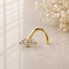 14K yellow gold double diamond nose ring twist, two prong-set round diamonds on reflective surface