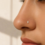 14K yellow gold double diamond nose stud shown in pierced nostril, side profile on model