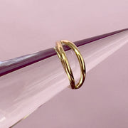 14k yellow gold double split seam ring displayed on a cone prop for size perspective