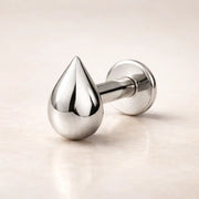 14k white gold droplet flat back labret stud with high-polish teardrop charm, side angle view