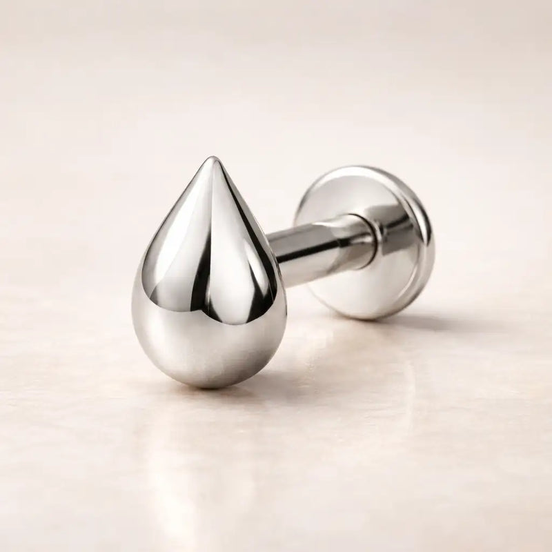 14k white gold droplet flat back labret stud with high-polish teardrop charm, side angle view