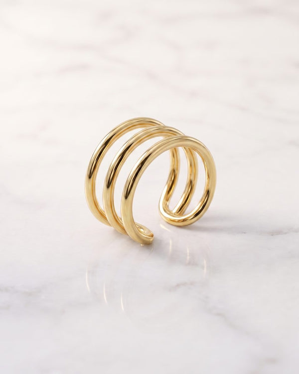 Ear cuffs - 14k yellow gold three band non-pierced ear cuff on white marble