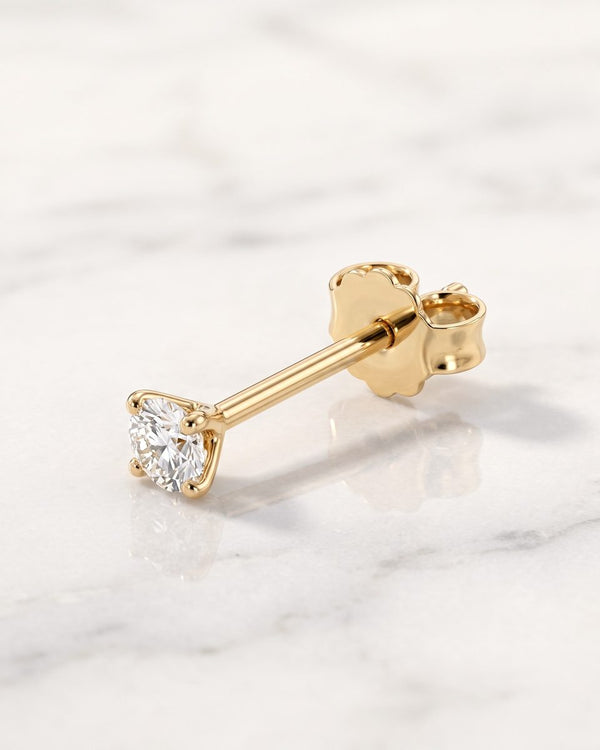 Stud earrings - 14k yellow gold prong-set diamond solitaire stud earring with butterfly back on white marble