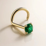 14K yellow gold genuine emerald nose ring twist style, angled view showing prong-set green stone
