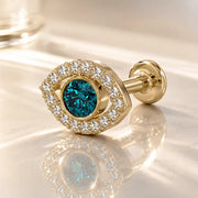 14k yellow gold evil eye flat back stud with blue topaz center and diamond halo, angled lifestyle shot