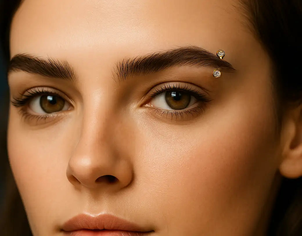 woman with diamond and gold eyebrow ring piercing.